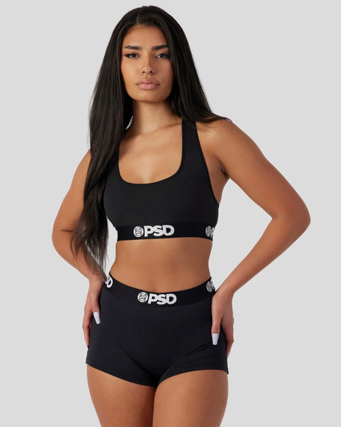 Black sports bra and shorts set with PSD branding on elastic waistbands.