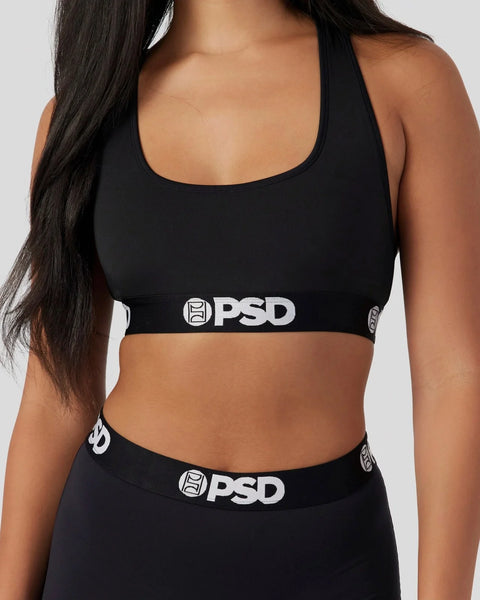 Black sports bra with PSD branding on elastic band and scoop neckline.