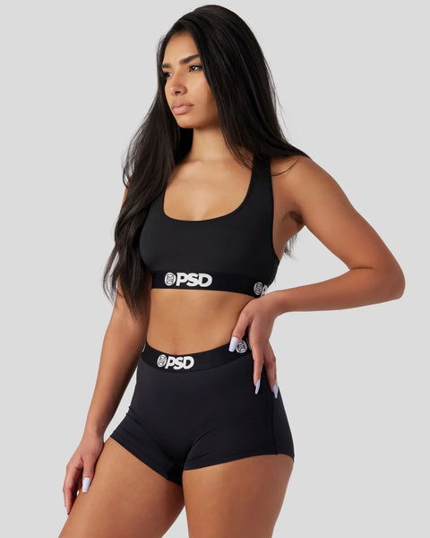 Black sports bra and matching boy shorts with PSD branding on elastic waistbands.