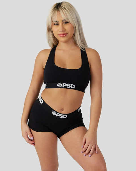 Black halter sports bra and matching shorts set with PSD branding on waistband.