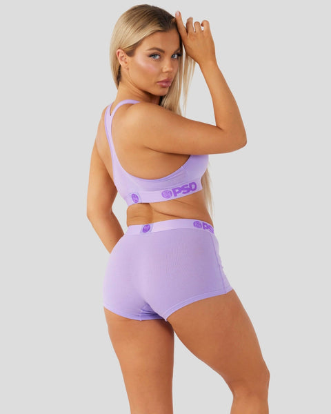 Lavender sports bra and shorts set with ribbed texture and branded waistband detail.