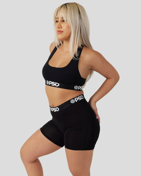 Black sports bra and shorts set with PSD branding on elastic waistbands.
