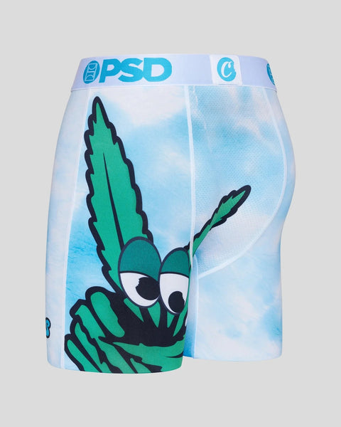 PSD brand underwear with green cartoon character and cloud sky graphic on light blue background.