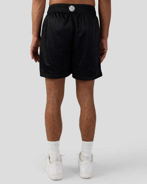 Black mesh athletic shorts with elastic waistband and white logo patch.