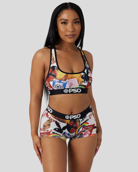 Woman wearing Playboy-branded sports bra and shorts with multicolor cover artwork and PSD waistband.