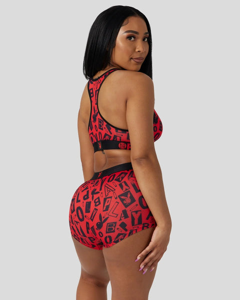 Red sports bra and briefs set with black symbol pattern and black trim details.