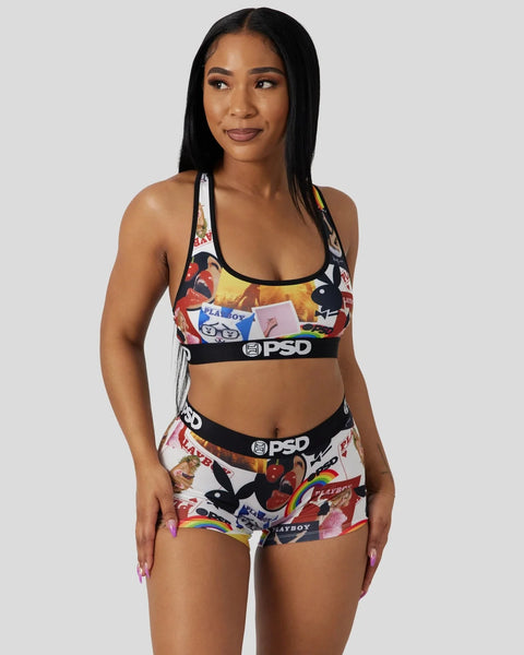 Woman wearing Playboy Covers sports bra and boy shorts set with multicolor magazine cover print and black PSD waistband.