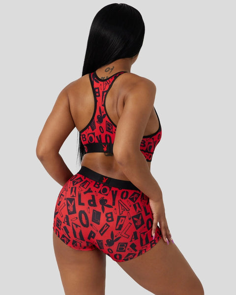 Red and black Playboy Anarchy sports bra and shorts set with all-over logo print, shown from back view.