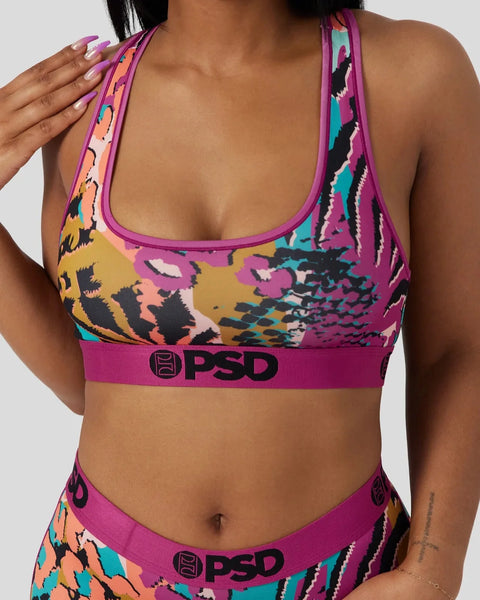 Multi-colored animal print sports bra with magenta trim and PSD branding on elastic band.