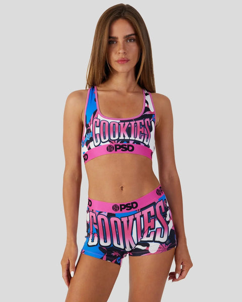 Woman wearing a pink and blue camo-print sports bra and shorts set with 