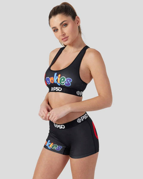 Woman wearing black sports bra and shorts set with colorful 