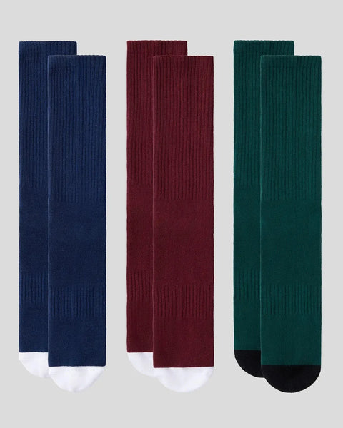 Three crew socks in navy, burgundy, and teal with contrasting white and black heel and toe.
