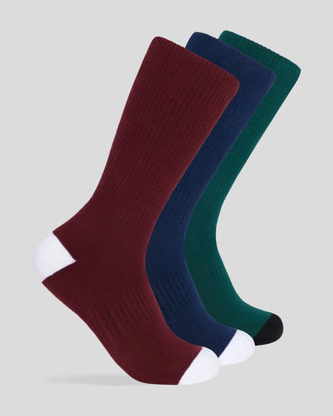 Three crew socks in burgundy, navy, and forest green with white and black toe accents.
