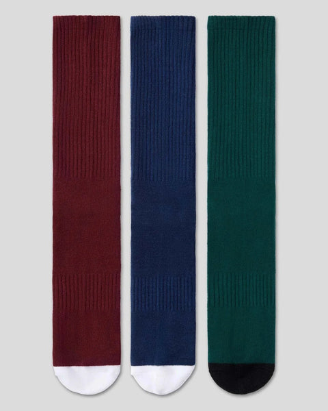 Three crew socks in burgundy, navy, and forest green with ribbed texture and contrasting toe caps.