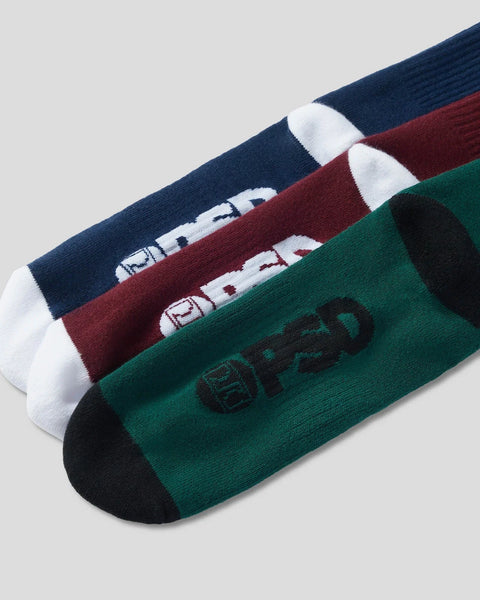 Three crew socks in navy, burgundy, and green with white toe and heel sections and logos on the cuff.