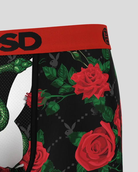 Red waistband with black text above black fabric featuring red roses, green leaves, and gray Playboy logos on repeat pattern.