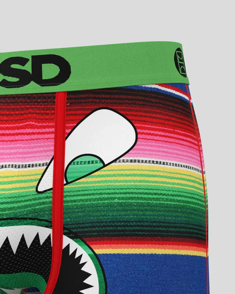 Colorful striped serape with green waistband, red seam, and black graphic face design featuring white and green details.