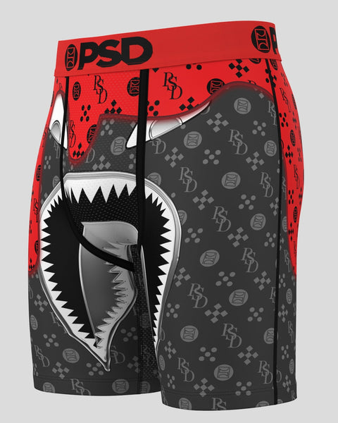 Red and charcoal boxer briefs with shark mouth graphic, PSD waistband, and repeating logo pattern.