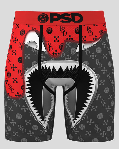PSD boxer briefs with red and gray color-blocked design, featuring large graphic monster face with sharp teeth and repeating 