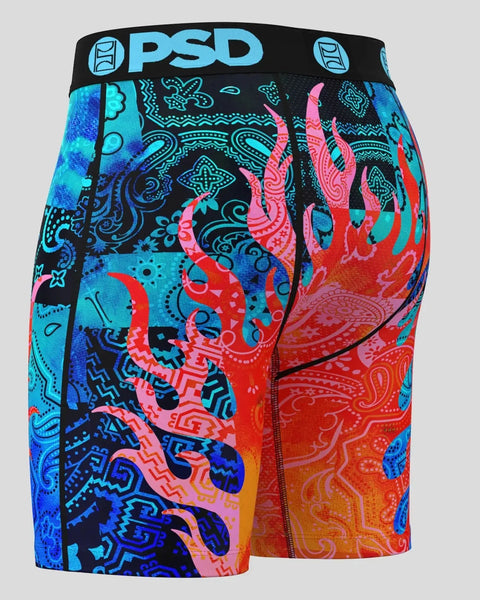 PSD boxer shorts with black waistband featuring bright blue, pink, red, and orange flame and paisley pattern throughout.