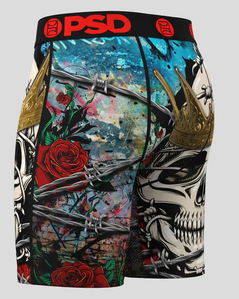 PSD underwear shorts with skull motifs, red roses, barbed wire graphics, and turquoise distressed background panel.