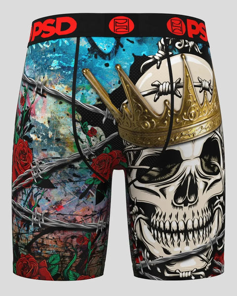 Black boxer briefs with skull wearing gold crown, red roses, and textured blue background, red PSD waistband.