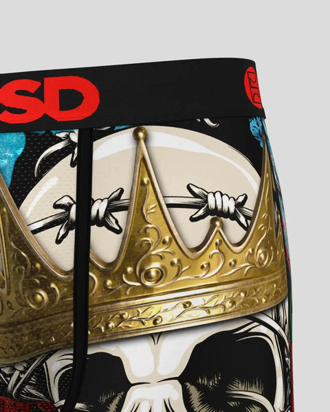 Gold ornate crown with decorative scrollwork on black and red fabric with text detailing.