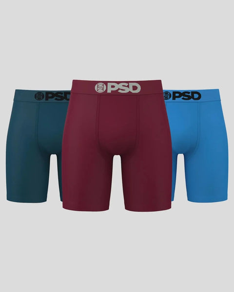 Three solid-colored boxer briefs in teal, burgundy, and blue with PSD waistbands.