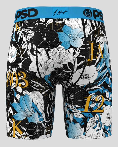 PSD boxer briefs with blue waistband, black and white floral pattern, blue flowers, and gold typography.
