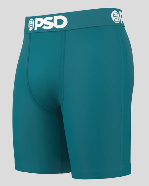 Teal boxer briefs with PSD waistband and center seam detail on gray background.