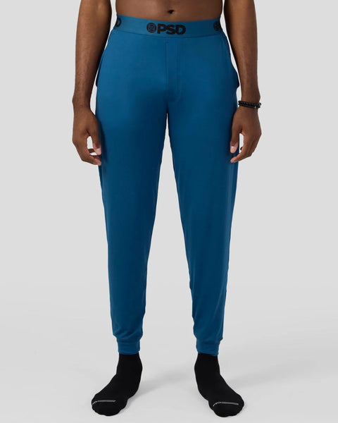 Teal lounge pant with PSD branded waistband and ribbed cuffs on model.