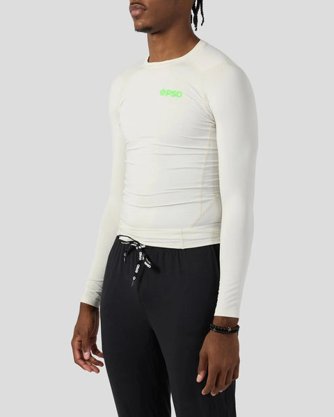Ash-colored long-sleeve compression tee with green logo on chest, fitted design with horizontal ruching.