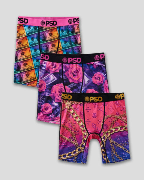 Three PSD boxer briefs with colorful prints: multicolored currency design, pink roses on black, and pink with gold chains on 