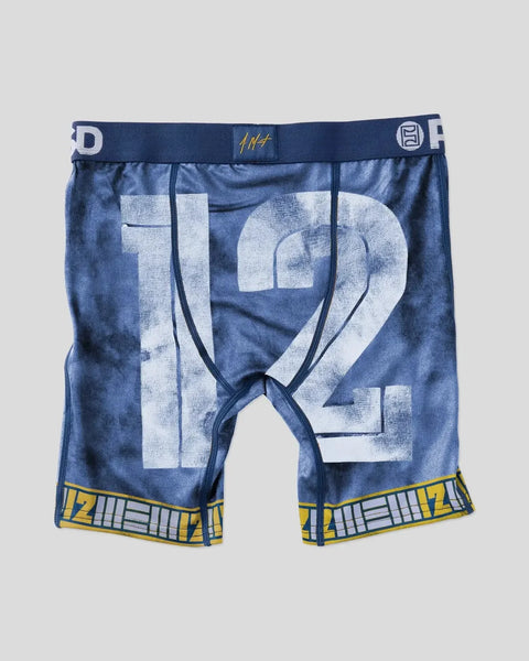 Navy blue compression shorts with large white number 12, gold waistband trim, and yellow leg bands.