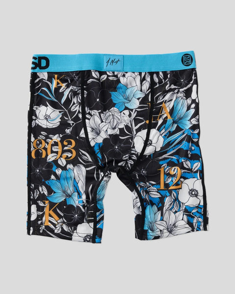 Black boxer briefs with blue and white floral print, gold text, and turquoise waistband.