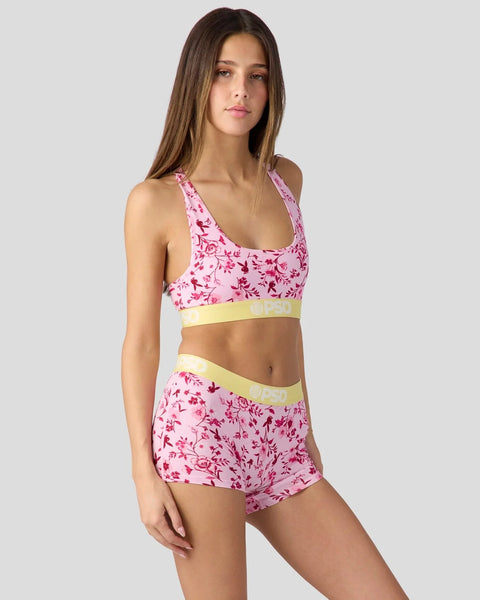 Pink floral racerback sports bra and shorts set with yellow waistband trim.