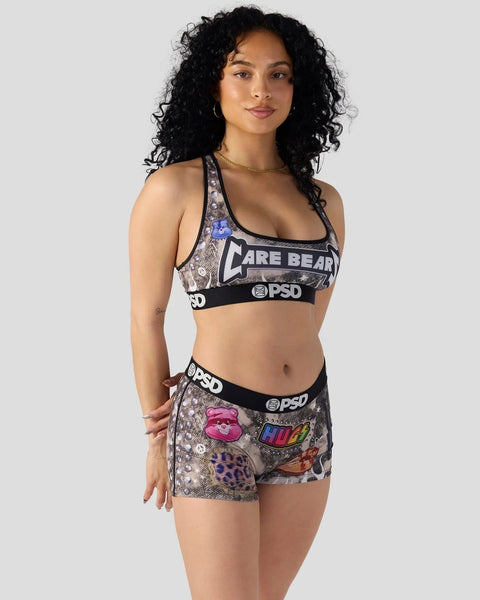 Woman wearing Care Bears-branded sports bra and shorts with graphic prints and PSD waistband.
