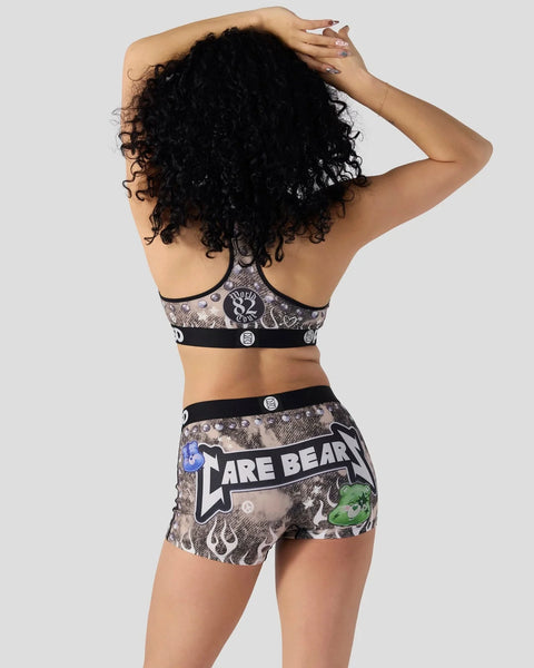 Care Bears patterned sports bra and shorts set with bear graphics and black bands, shown from back.