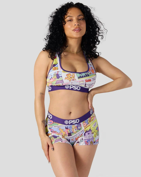 Woman wearing Care Bears comic print sports bra and boyshort set with purple PSD waistband.