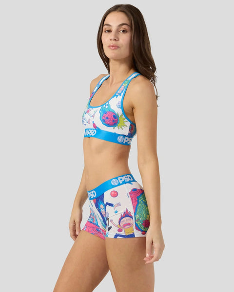 Woman wearing blue and white Rick and Morty print sports bra and matching shorts with blue waistband.