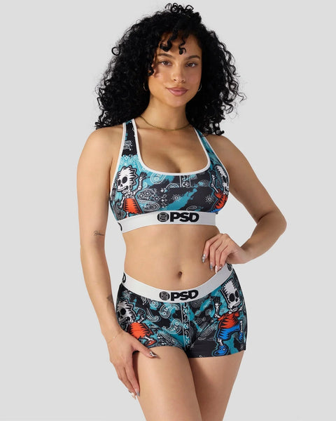 Woman wearing PSD sports bra and shorts with Simpsons zombie-themed graphic print in black, blue, and red.