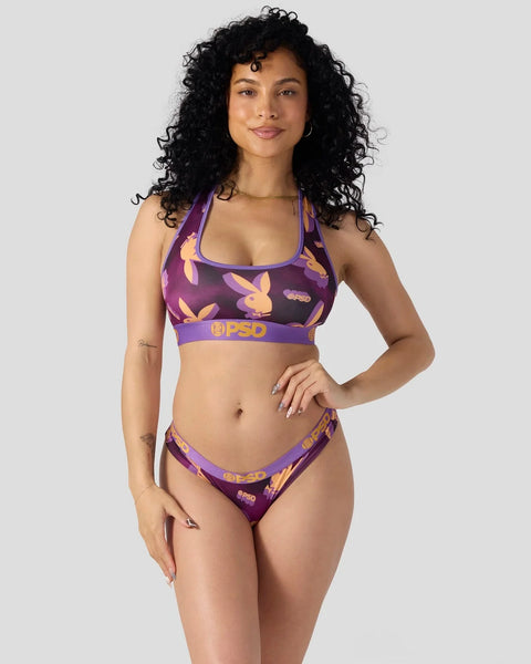 Purple and gold Playboy-branded two-piece swimsuit with bunny print and purple elastic bands.