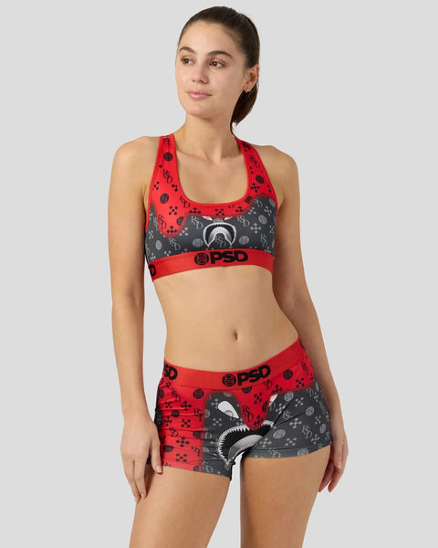 Red and gray sports bra and shorts set with graphic print and branded elastic bands.
