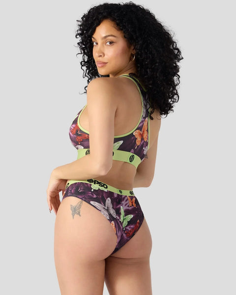 Dark purple floral sports bra and briefs set with neon green trim and branding details.