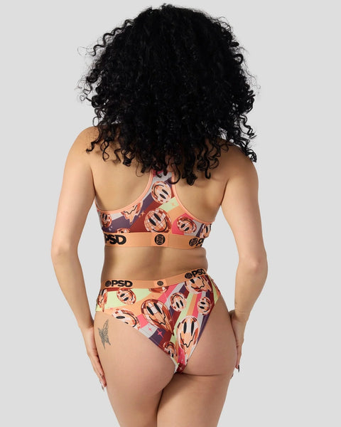 Person wearing colorful patterned sports bra and briefs set with geometric design and branded elastic bands.