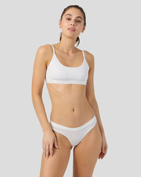 Woman wearing white modal sports bra and matching bikini briefs.