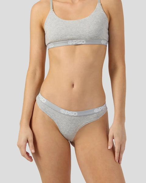 Woman wearing light gray modal bra and matching bikini briefs with elastic waistband.