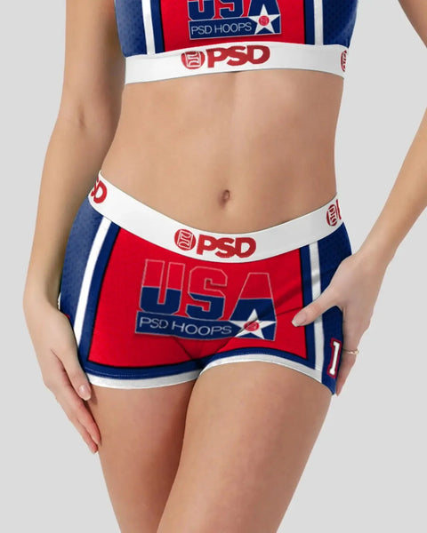 Red, white, and navy sports bra and shorts set with USA and PSD Hoops branding.