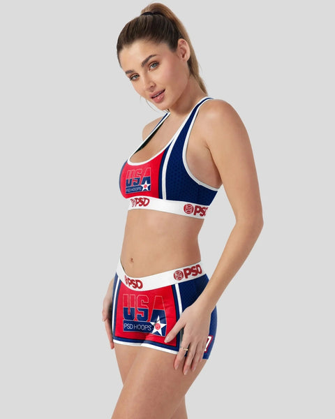 Woman wearing red, white, and navy USA-themed sports bra and matching shorts with PSD branding.
