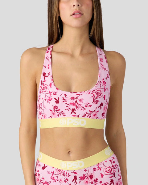 Pink floral sports bra with yellow waistband and matching pink floral bottoms with yellow trim.